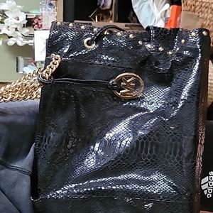 Michael Kors black lizard purse with brass accents, 2 outside  side pockets